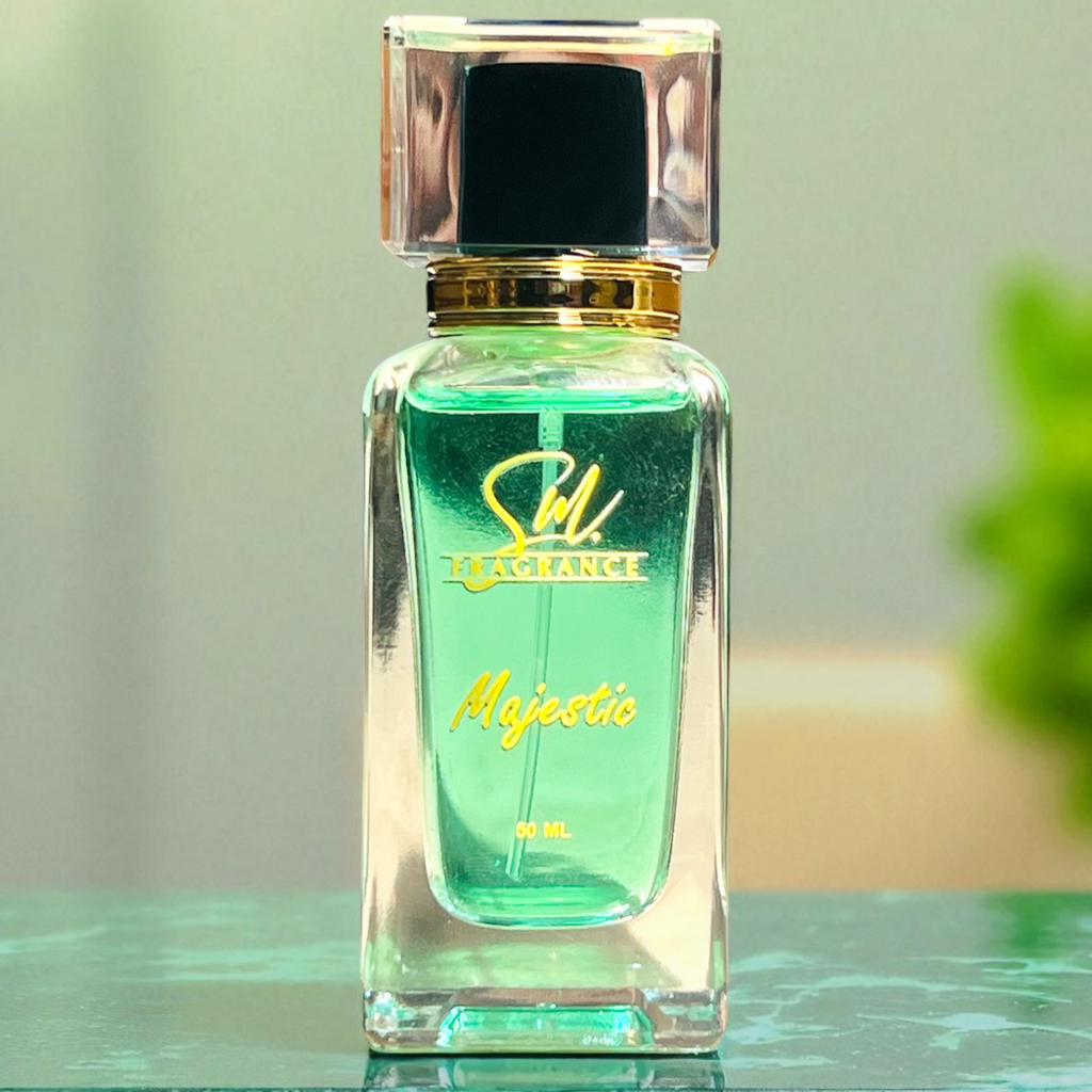 Green perfume bottle with gold cap on a reflective surface