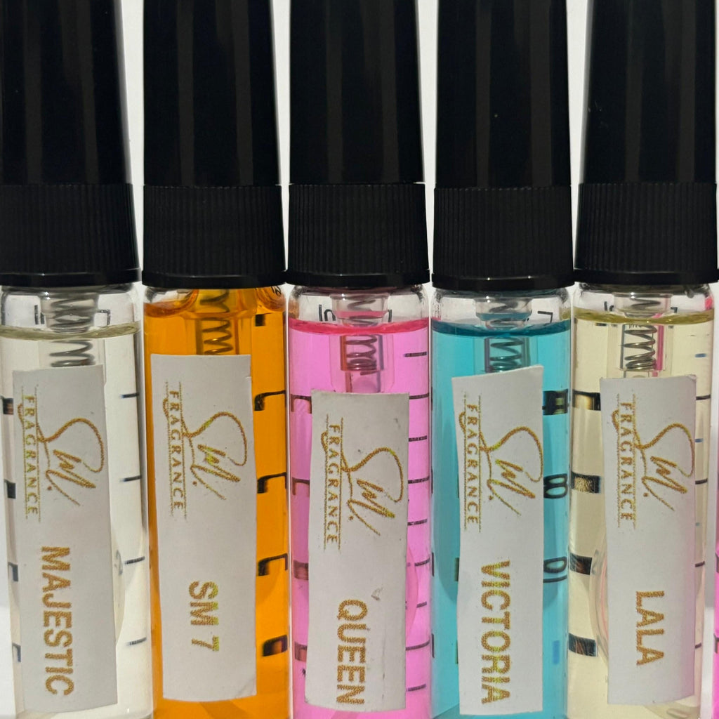 Set of small perfume bottles with colorful labels on a white background