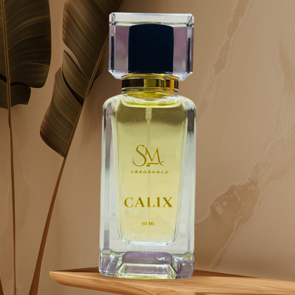 Perfume bottle labeled 'Calix' by SM Fragrances on a wooden shelf with a plant in the background.